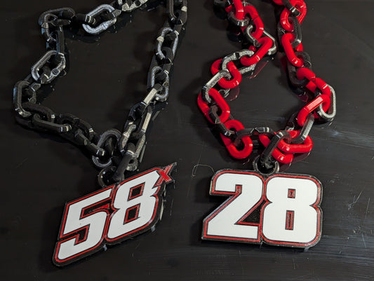 Two printed racing-number pendants on oversized linked chains