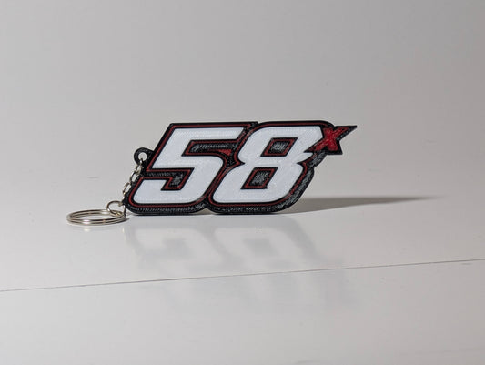 White racing-number keychain with red & black layers and a metal keyring