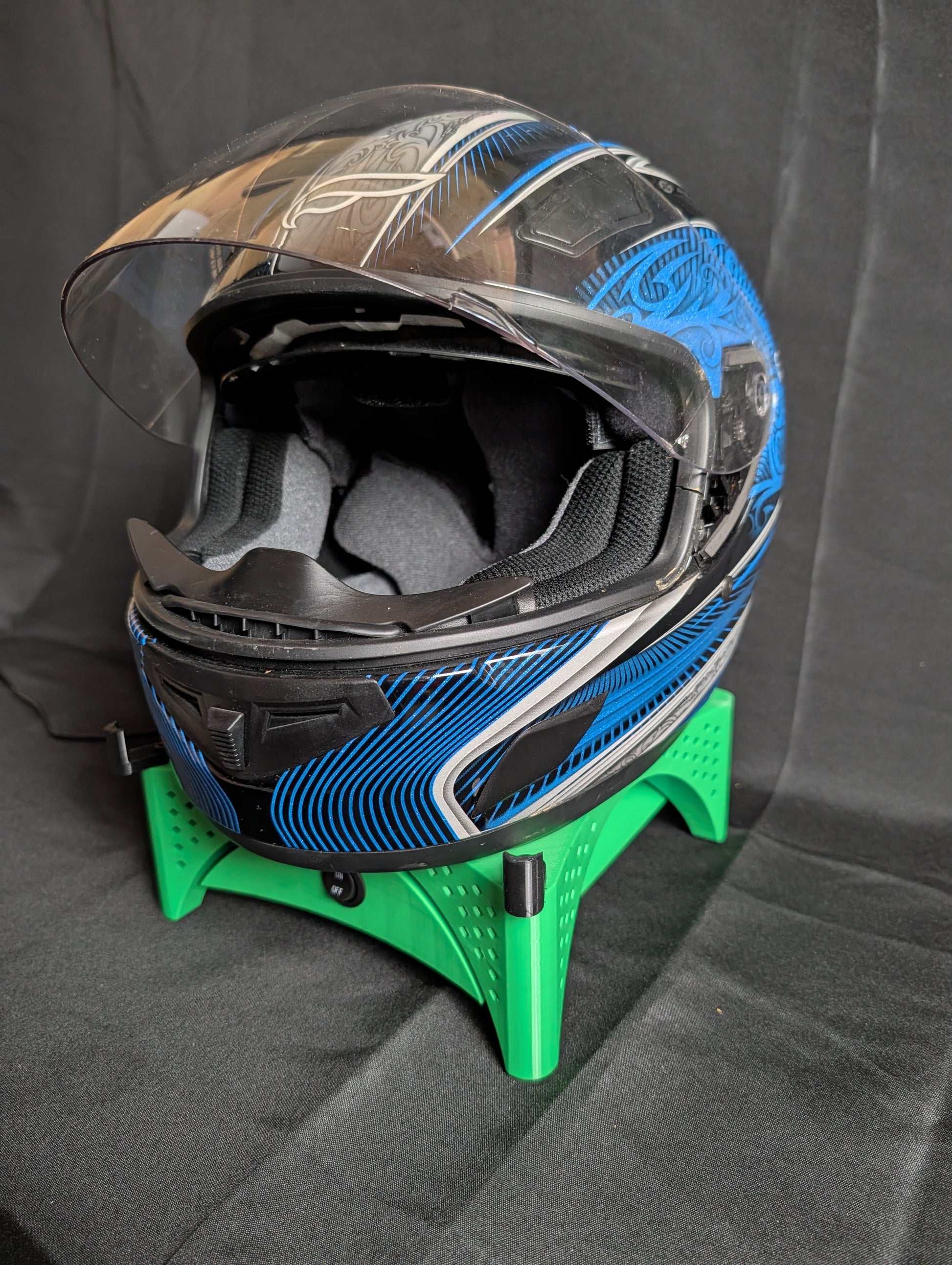 Motorcycle helmet drying on the Trackside AirFlow helmet stand