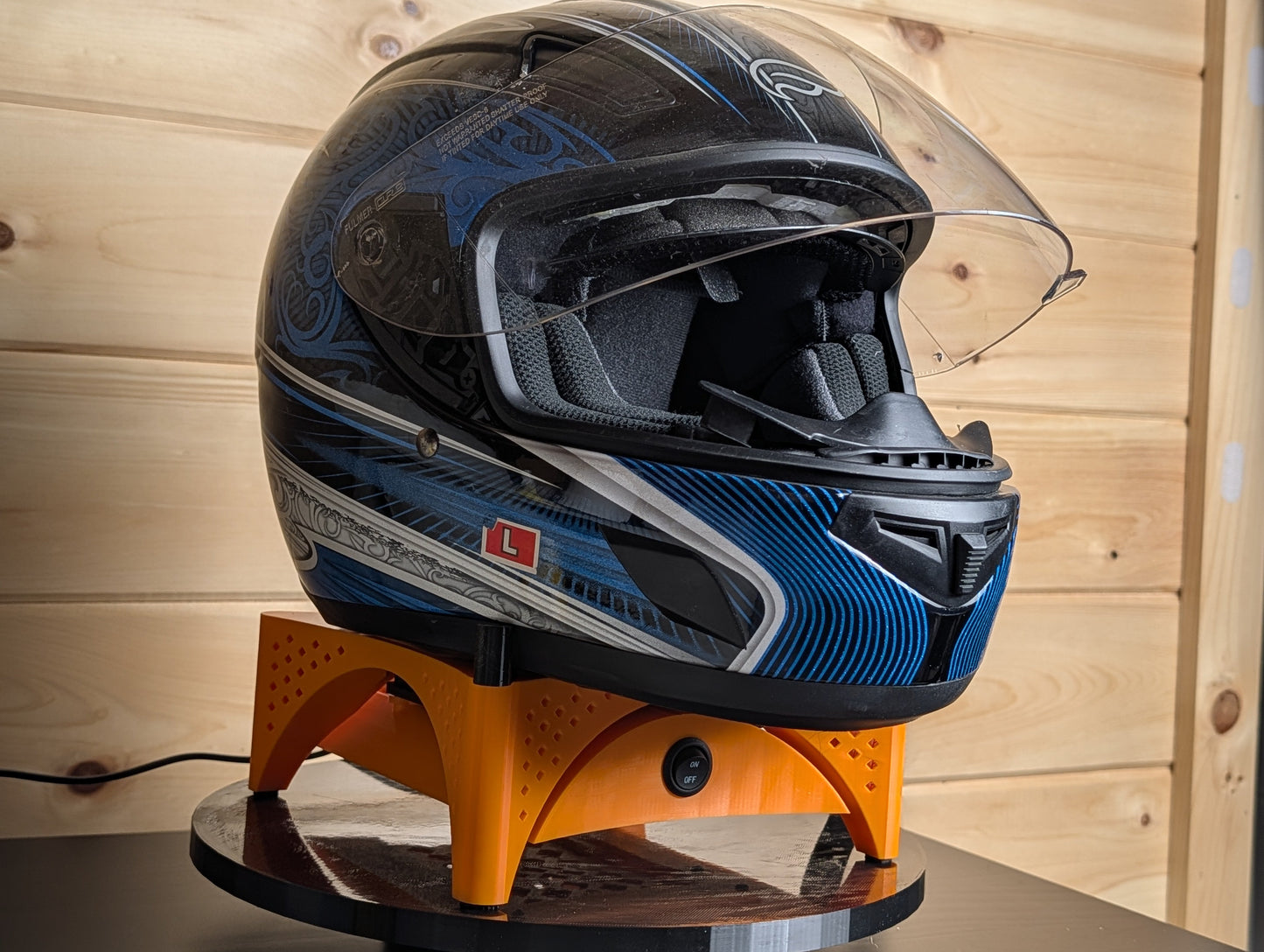 Blue Trackside AirFlow helmet stand showing the cooling fan