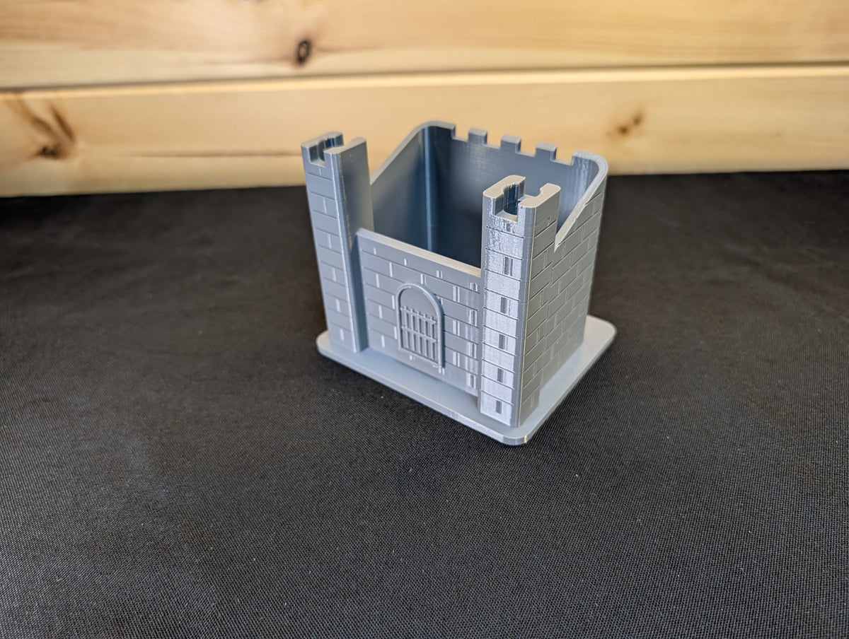 Empty grey castle pen holder showing storage space and corner towers