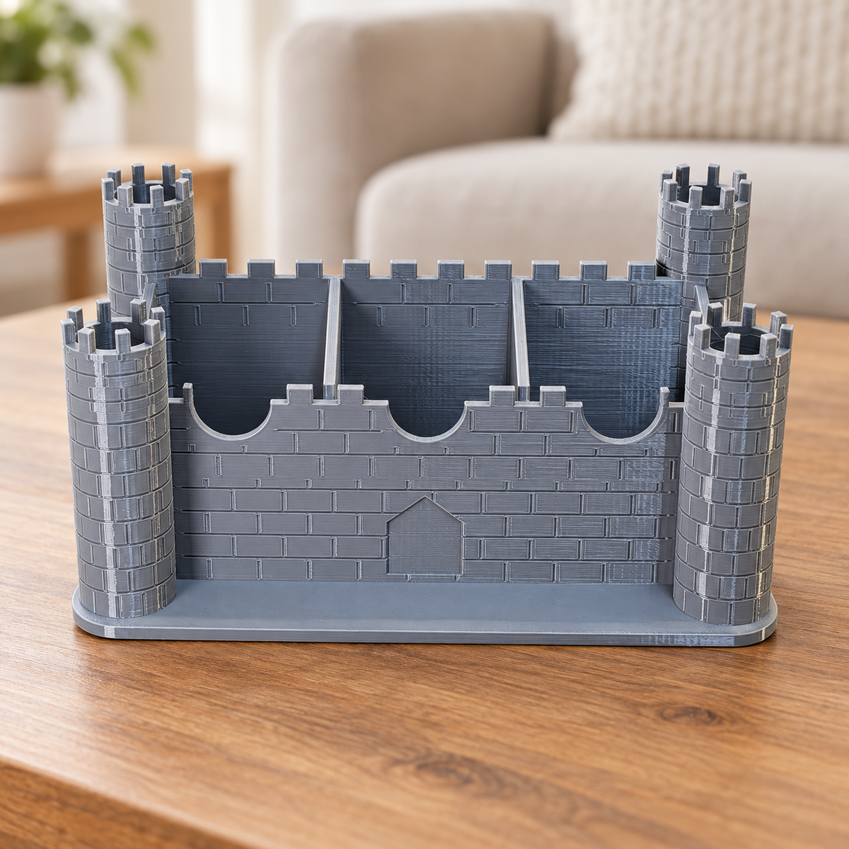 Empty Grey PETG castle remote holder showing three compartments; retouched background