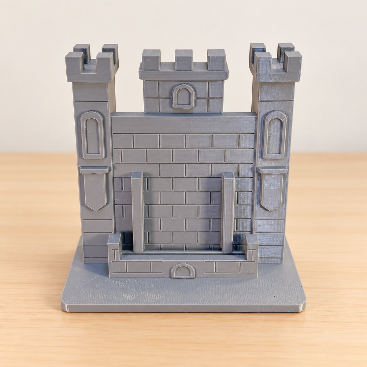 Tall grey castle tower trading-card stand, empty, with an edited neutral background