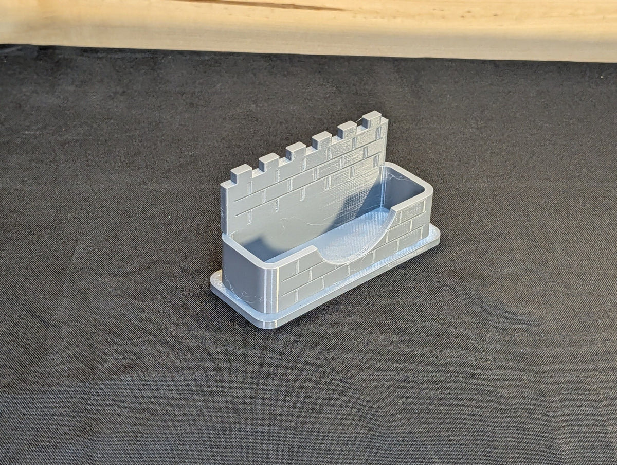 Original angled view of the empty castle wall business card holder