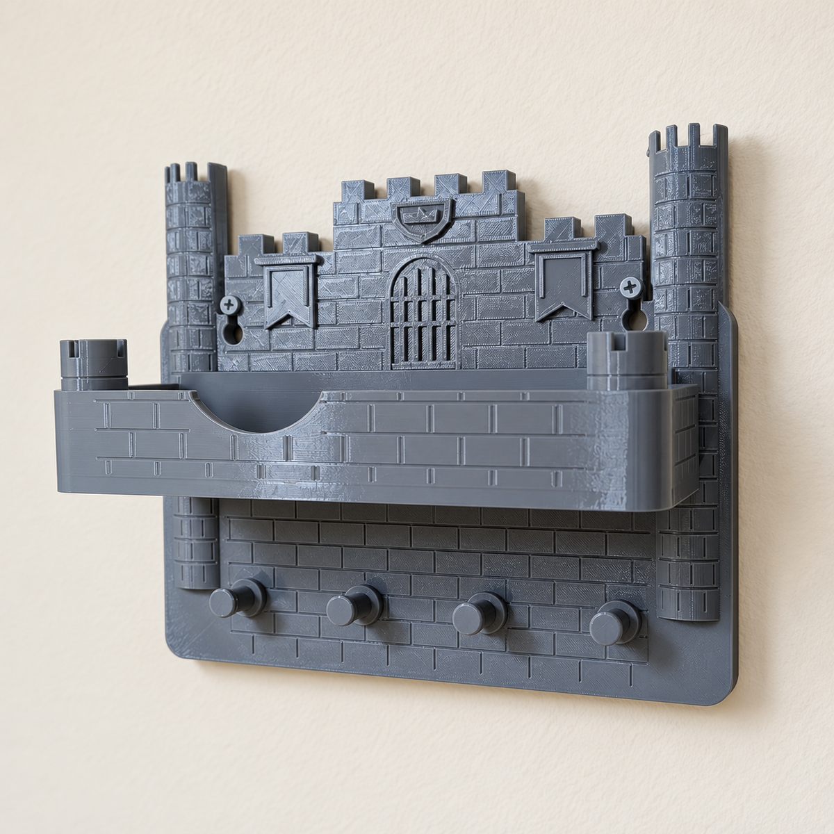 Grey castle wall key holder with four pegs and removable tray, photographed with an edited neutral wall background
