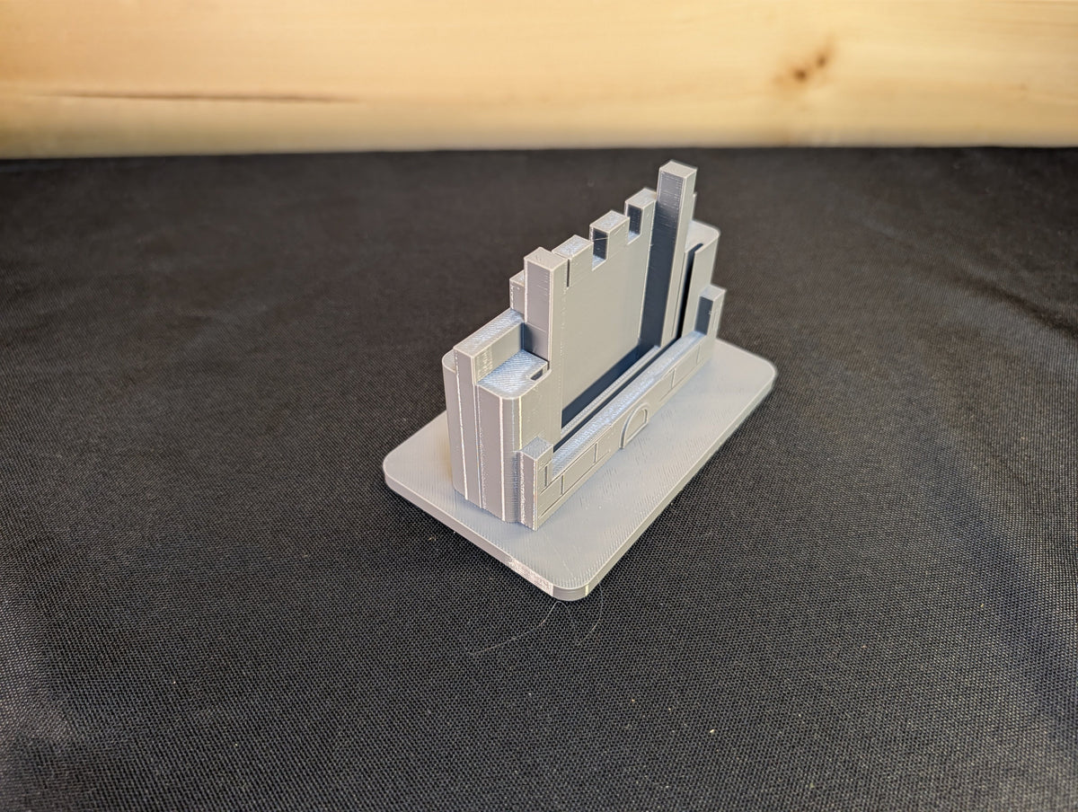 Actual compact castle stand from the side showing the card-holder slot and base