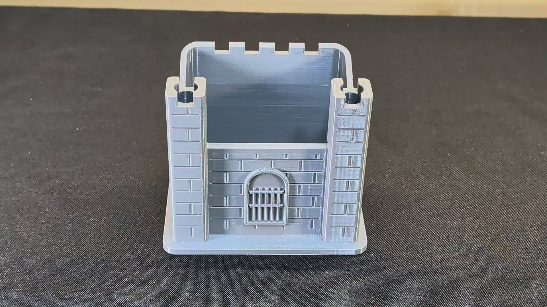 Actual grey castle pen holder with pens and markers