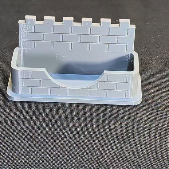Castle wall business card holder demonstration with a card placed into the pocket