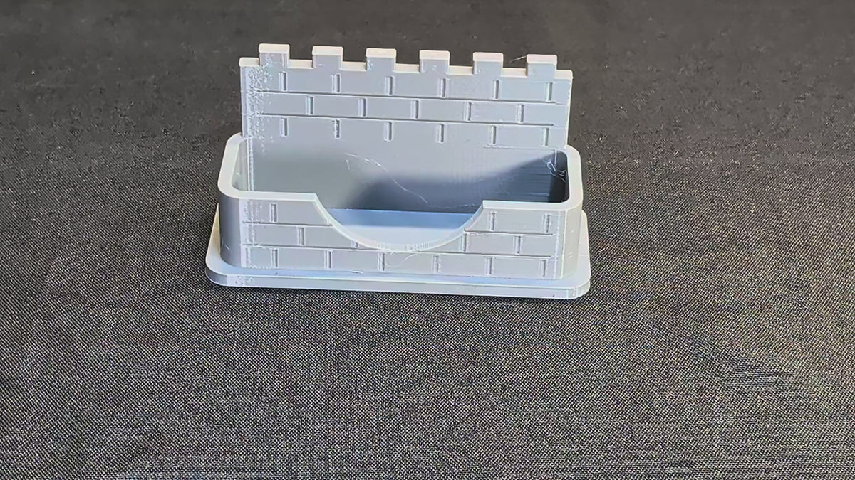 Castle wall business card holder demonstration with a card placed into the pocket
